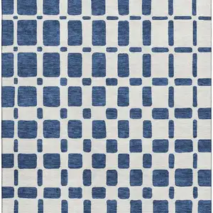 Photo of Navy Blue And Ivory Geometric Washable Area Rug With UV Protection
