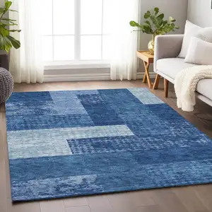 Photo of Navy Blue And Ivory Geometric Washable Area Rug With UV Protection