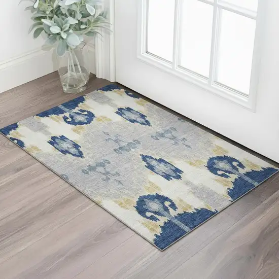 Navy Blue Gold And Ivory Ikat Washable Area Rug With UV Protection Photo 1