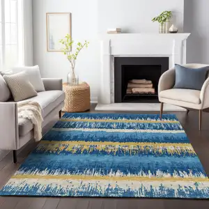 Photo of Navy Blue Gold And Ivory Striped Washable Indoor Outdoor Area Rug