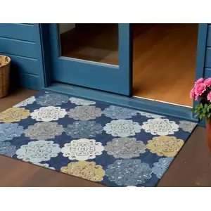 Photo of Navy Blue Ivory And Gold Quatrefoil Washable Indoor Outdoor Area Rug
