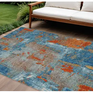 Photo of Navy Blue Orange And Ivory Abstract Washable Indoor Outdoor Area Rug