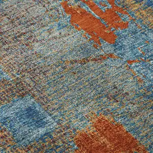 Photo of Navy Blue Orange And Teal Abstract Washable Area Rug With UV Protection