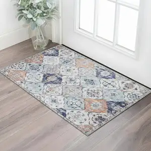 Photo of Navy Blue Orange And White Patchwork Distressed Washable Area Rug