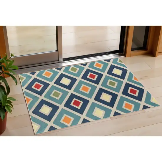 Blue And Ivory Geometric Stain Resistant Indoor Outdoor Area Rug Photo 1