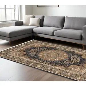 Photo of Navy Blue Tan And Ivory Medallion Area Rug With Fringe