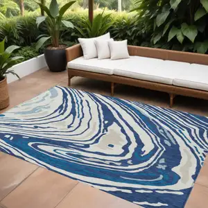 Photo of Navy Blue Teal Blue And Ivory Abstract Washable Indoor Outdoor Area Rug