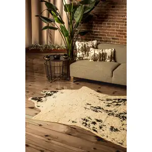 Photo of Off White Black and Gold Faux Cowhide Washable Area Rug