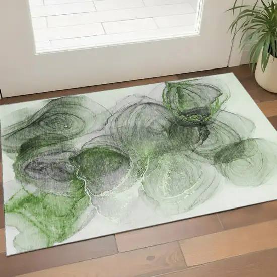 Olive Green And Ivory Abstract Washable Area Rug With UV Protection Photo 1