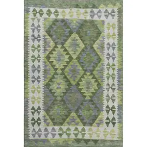 Photo of Olive Green And Ivory Tribal Washable Area Rug With UV Protection