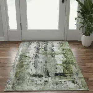 Photo of Olive Green Charcoal And Ivory Abstract Washable Area Rug With UV Protection