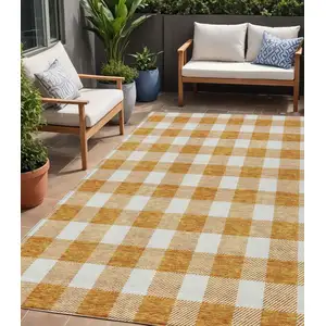 Photo of Orange And Beige Plaid Washable Indoor Outdoor Area Rug