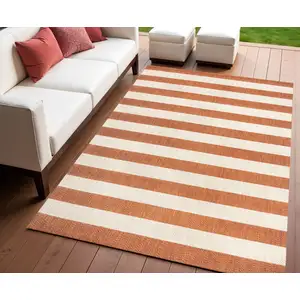 Photo of Orange And Beige Striped Indoor Outdoor Area Rug