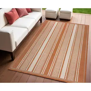 Photo of Orange And Cream Striped Indoor Outdoor Area Rug