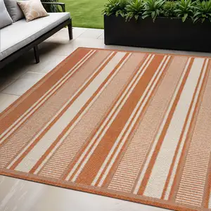 Photo of Orange And Cream Striped Indoor Outdoor Area Rug