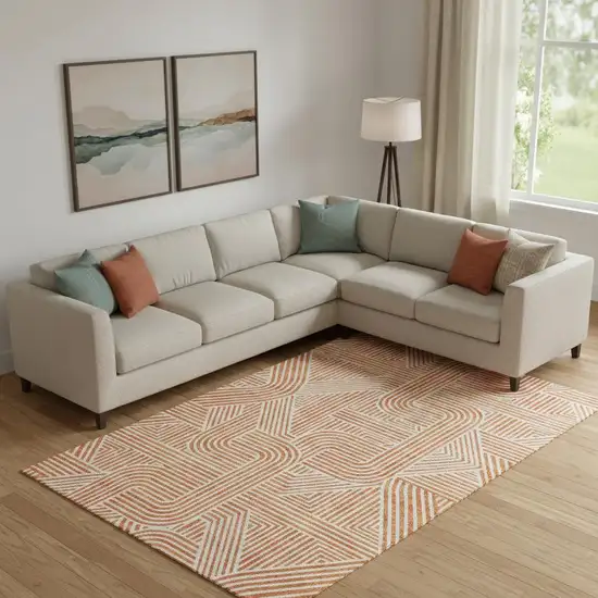 Orange And Ivory Abstract Geometric Washable Area Rug With UV Protection Photo 1