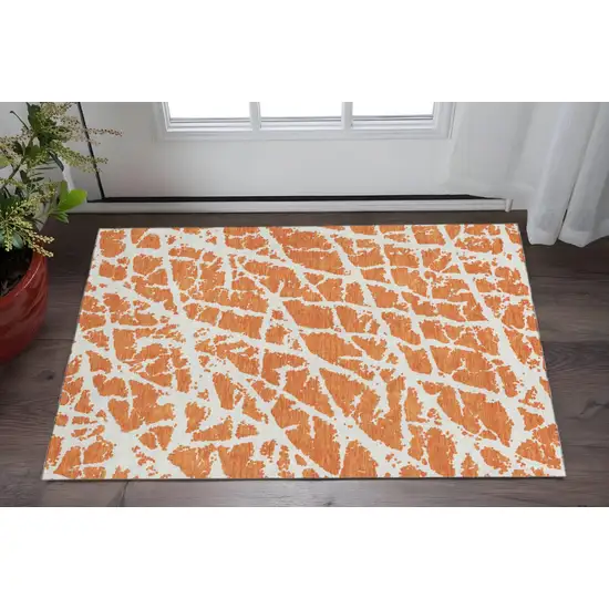 Orange And Ivory Abstract Washable Area Rug With UV Protection Photo 2