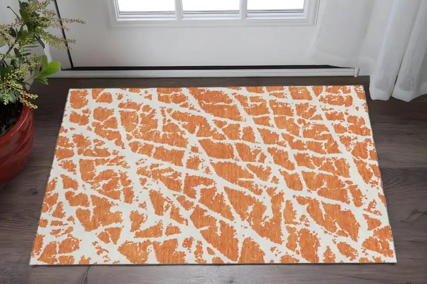 Orange And Ivory Abstract Washable Area Rug With UV Protection Photo 2