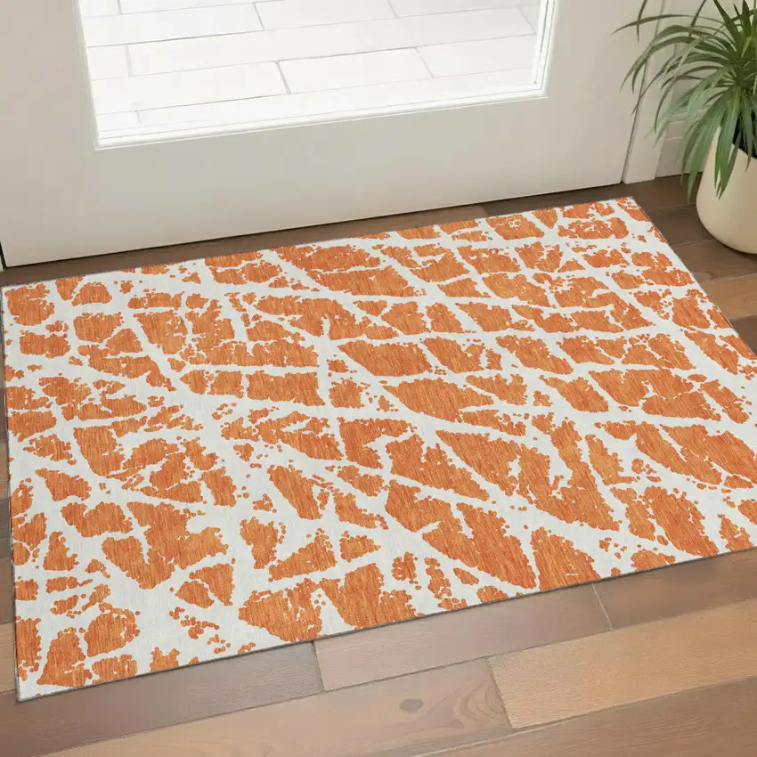 Orange And Ivory Abstract Washable Area Rug With UV Protection Photo 1