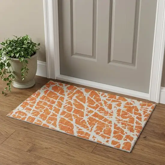Orange And Ivory Abstract Washable Area Rug With UV Protection Photo 1