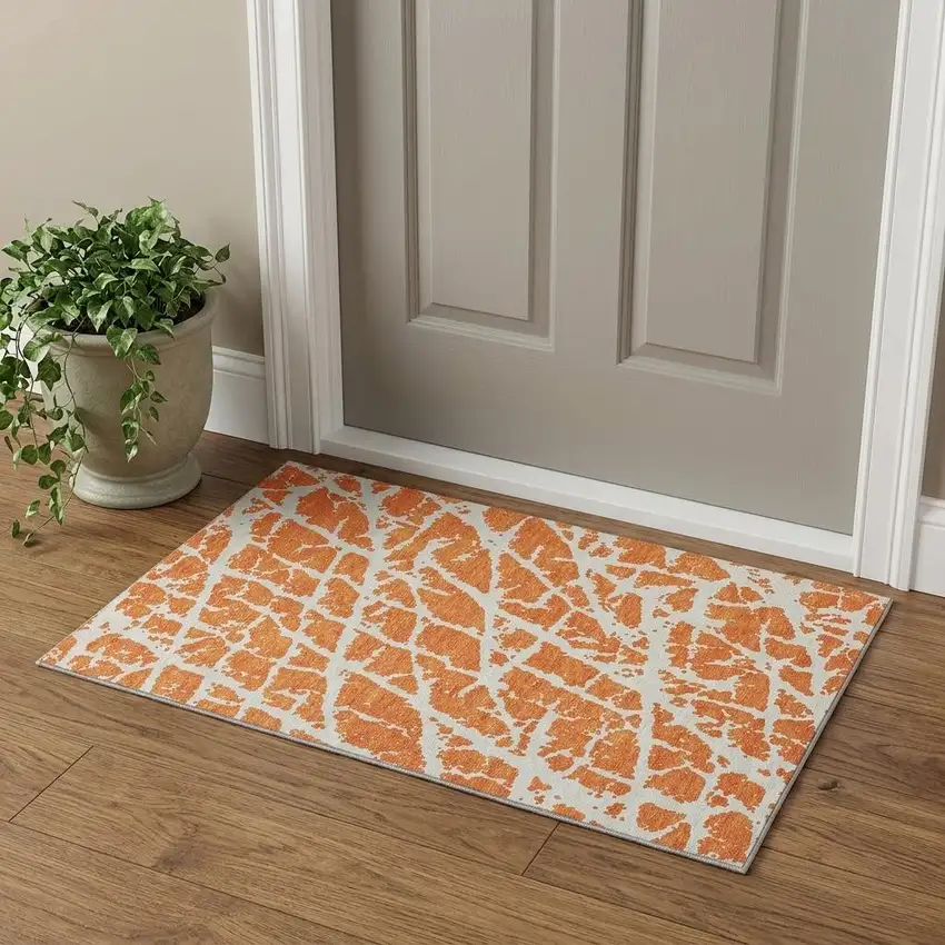 Orange And Ivory Abstract Washable Area Rug With UV Protection Photo 1