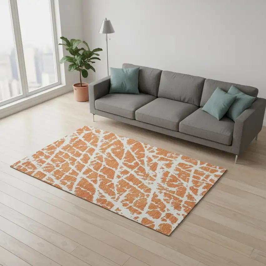 Orange And Ivory Abstract Washable Area Rug With UV Protection Photo 1