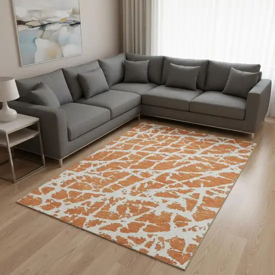 Orange And Ivory Abstract Washable Area Rug With UV Protection Photo 1