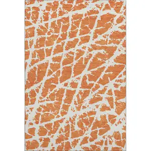 Photo of Orange And Ivory Abstract Washable Area Rug With UV Protection