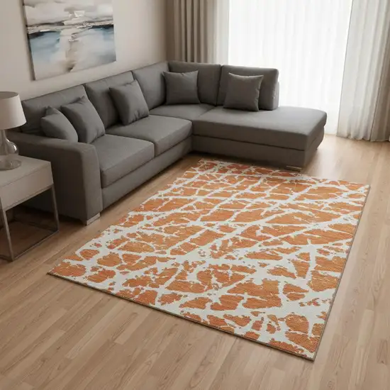 Orange And Ivory Abstract Washable Area Rug With UV Protection Photo 1