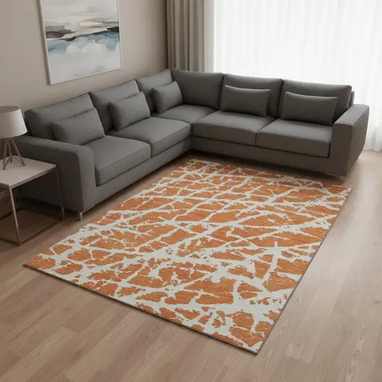 Orange And Ivory Abstract Washable Area Rug With UV Protection Photo 1