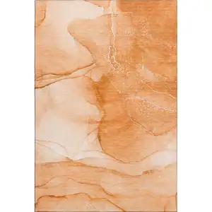 Photo of Orange And Ivory Abstract Washable Area Rug With UV Protection