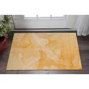 Photo of Orange And Ivory Abstract Washable Area Rug With UV Protection