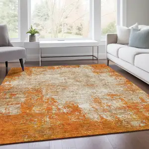Photo of Orange And Ivory Abstract Washable Area Rug With UV Protection