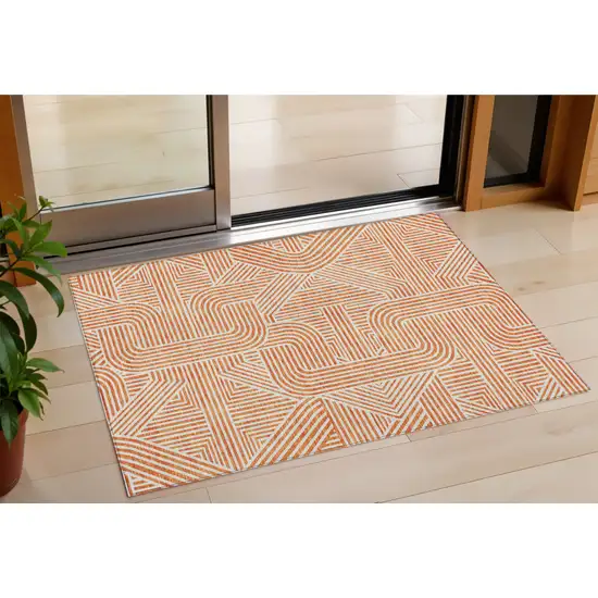 Orange And Ivory Abstract Washable Indoor Outdoor Area Rug Photo 1