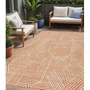 Photo of Orange And Ivory Abstract Washable Indoor Outdoor Area Rug