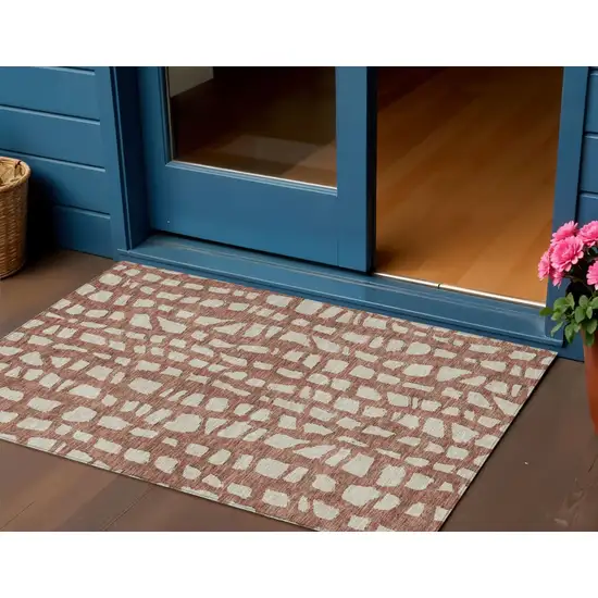 Orange And Ivory Abstract Washable Indoor Outdoor Area Rug Photo 1