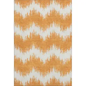 Photo of Orange And Ivory Chevron Washable Area Rug With UV Protection