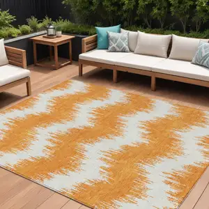 Photo of Orange And Ivory Chevron Washable Indoor Outdoor Area Rug