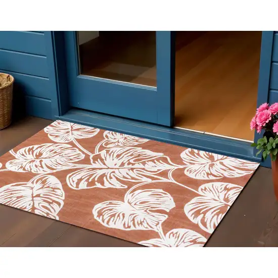 Orange And Ivory Floral Indoor Outdoor Area Rug Photo 1