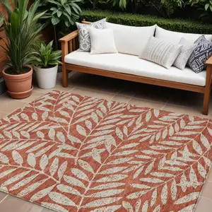 Photo of Orange And Ivory Floral Washable Indoor Outdoor Area Rug