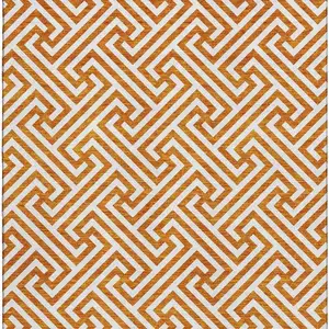 Photo of Orange And Ivory Geometric Washable Area Rug With UV Protection