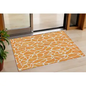 Photo of Orange And Ivory Geometric Washable Indoor Outdoor Area Rug
