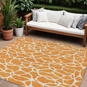 Photo of Orange And Ivory Geometric Washable Indoor Outdoor Area Rug