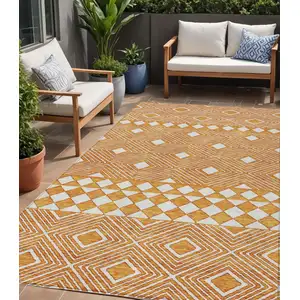 Photo of Orange And Ivory Geometric Washable Indoor Outdoor Area Rug