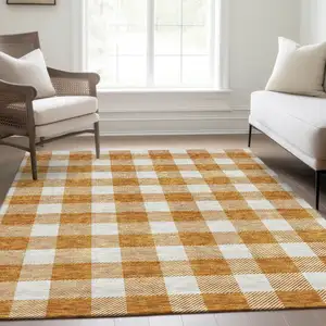 Photo of Orange And Ivory Plaid Washable Area Rug With UV Protection