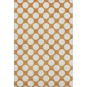 Photo of Orange And Ivory Polka Dot Washable Area Rug With UV Protection