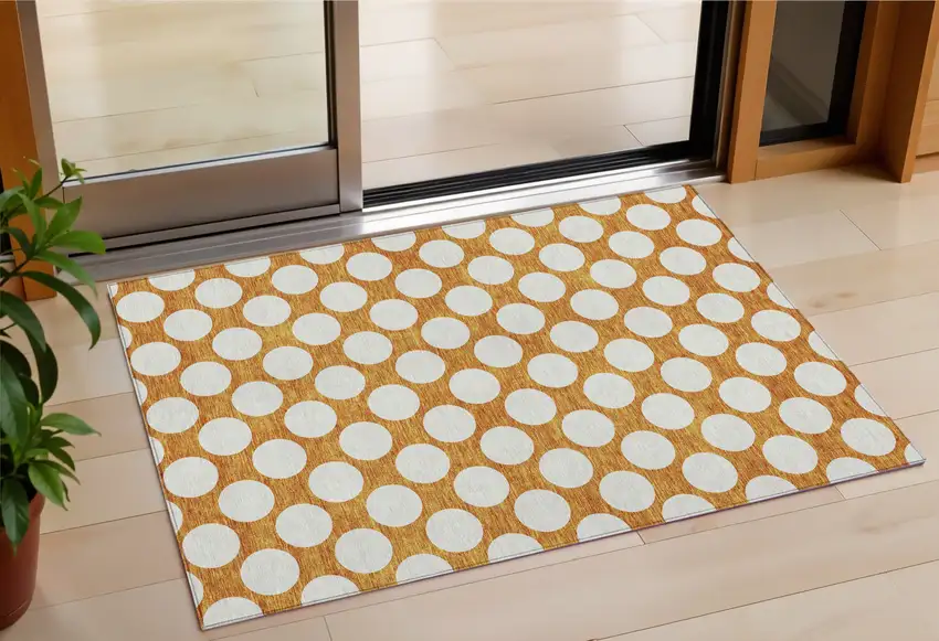 Orange And Ivory Polka Dot Washable Indoor Outdoor Area Rug Photo 1
