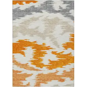 Photo of Orange Beige And Ivory Abstract Washable Indoor Outdoor Area Rug