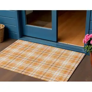 Photo of Orange Blue And Ivory Plaid Washable Indoor Outdoor Area Rug