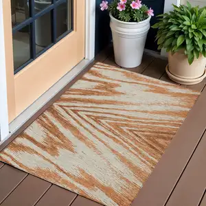 Photo of Orange Brown And Beige Abstract Washable Indoor Outdoor Area Rug